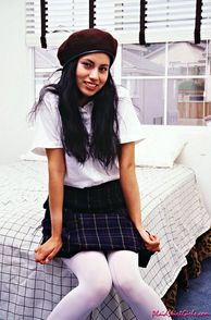 Latina Teen School Girl Sitting On Bed